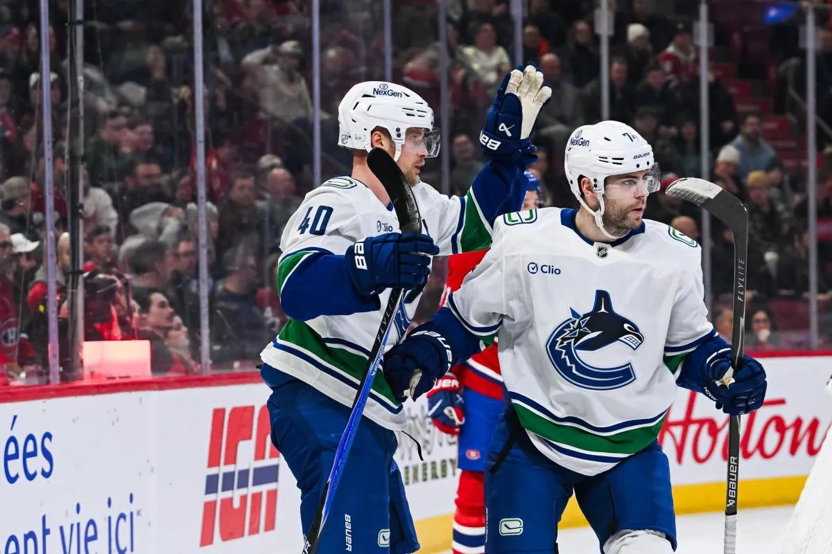 Vancouver Canucks center Elias Pettersson (40) celebrates with left wing Jake DeBrusk (74) his goal against the Montreal Canadiens during the first period at Bell Centre.