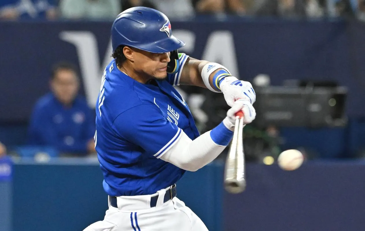 Toronto Blue Jays shortstop Santiago Espinal (5) hits an RBI double against the Cleveland Guardians in the fourth inning at Rogers Centre.