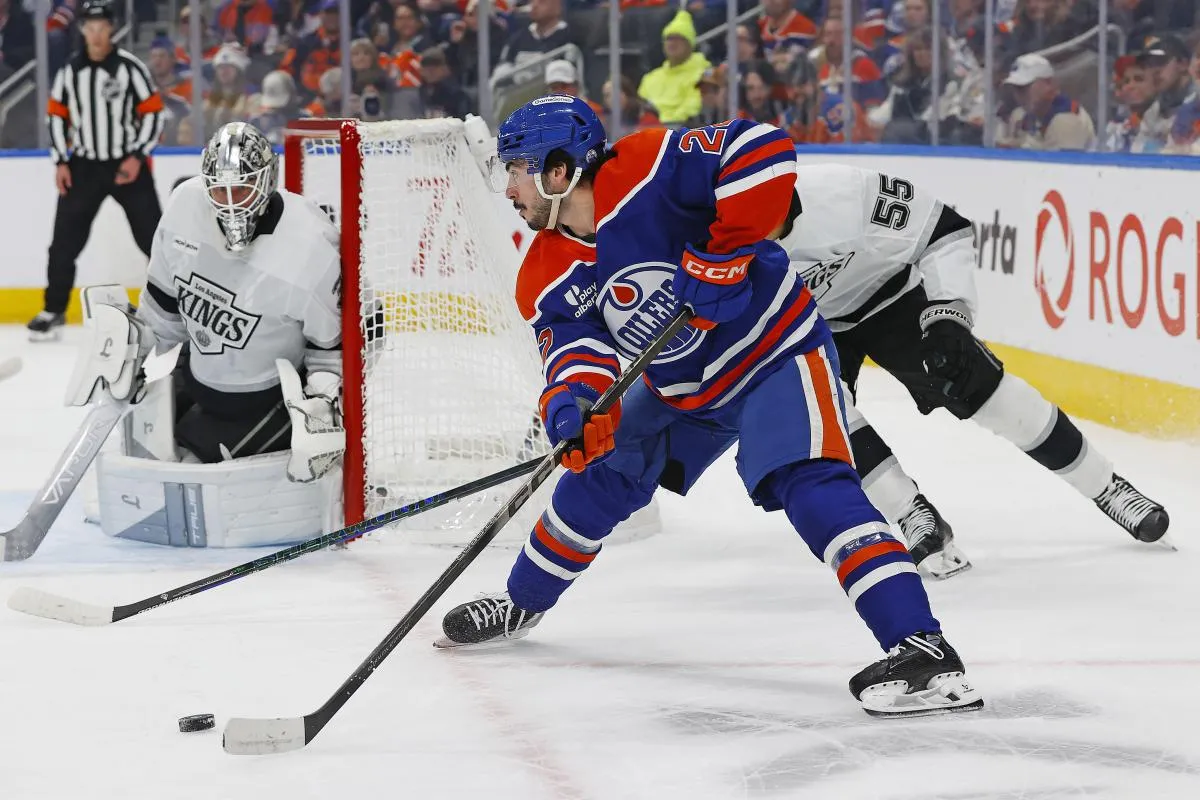 Edmonton Oilers forward Matt Savoie (22) looks to make a pass in front of Los Angeles Kings forward Quinton Byfield (55) at Rogers Place.