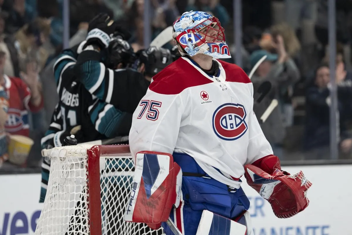 Montreal Canadiens goaltender Jakub Dobes (75) watches the big screen as the San Jose Sharks celebrate behind him during the second period at SAP Center at San Jose.