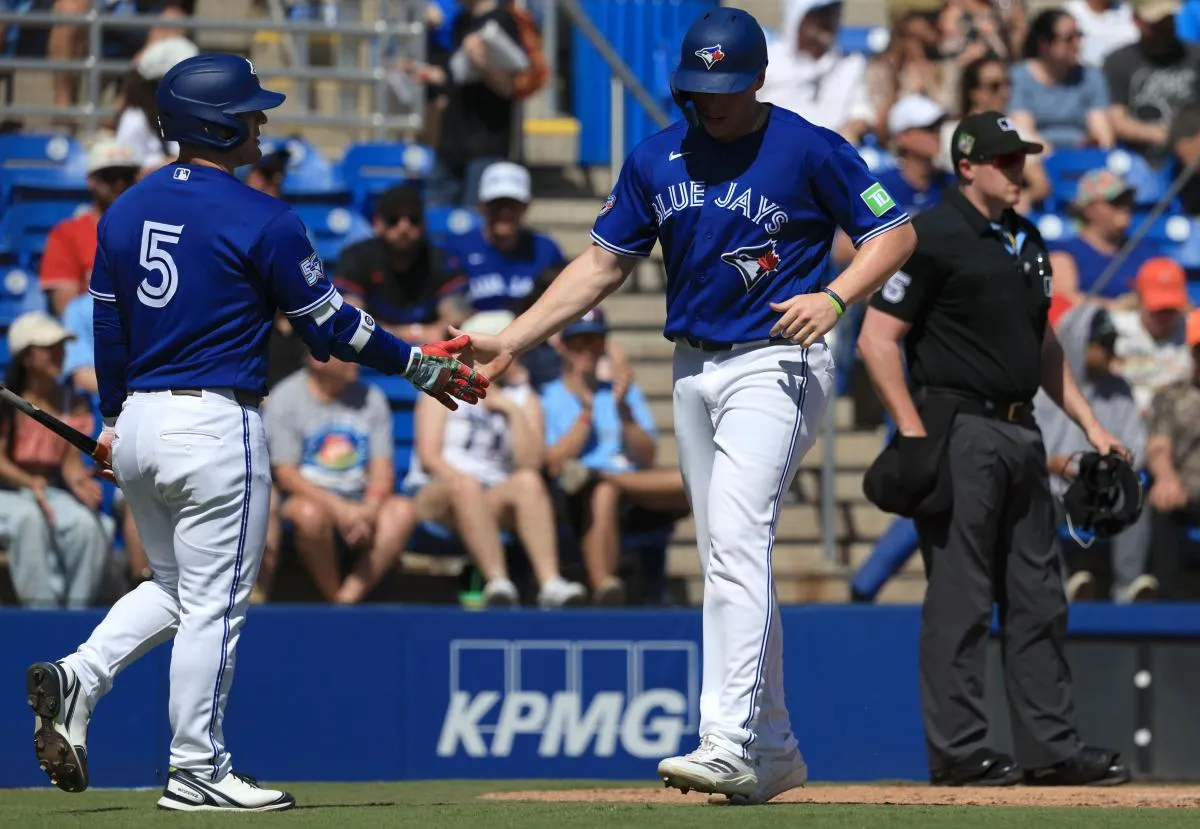 Toronto Blue Jays third baseman Sean Keys (89) is congratulated by center fielder Daulton Varsho (5) after he scored a run against Team Canada during the second inning at TD Ballpark.