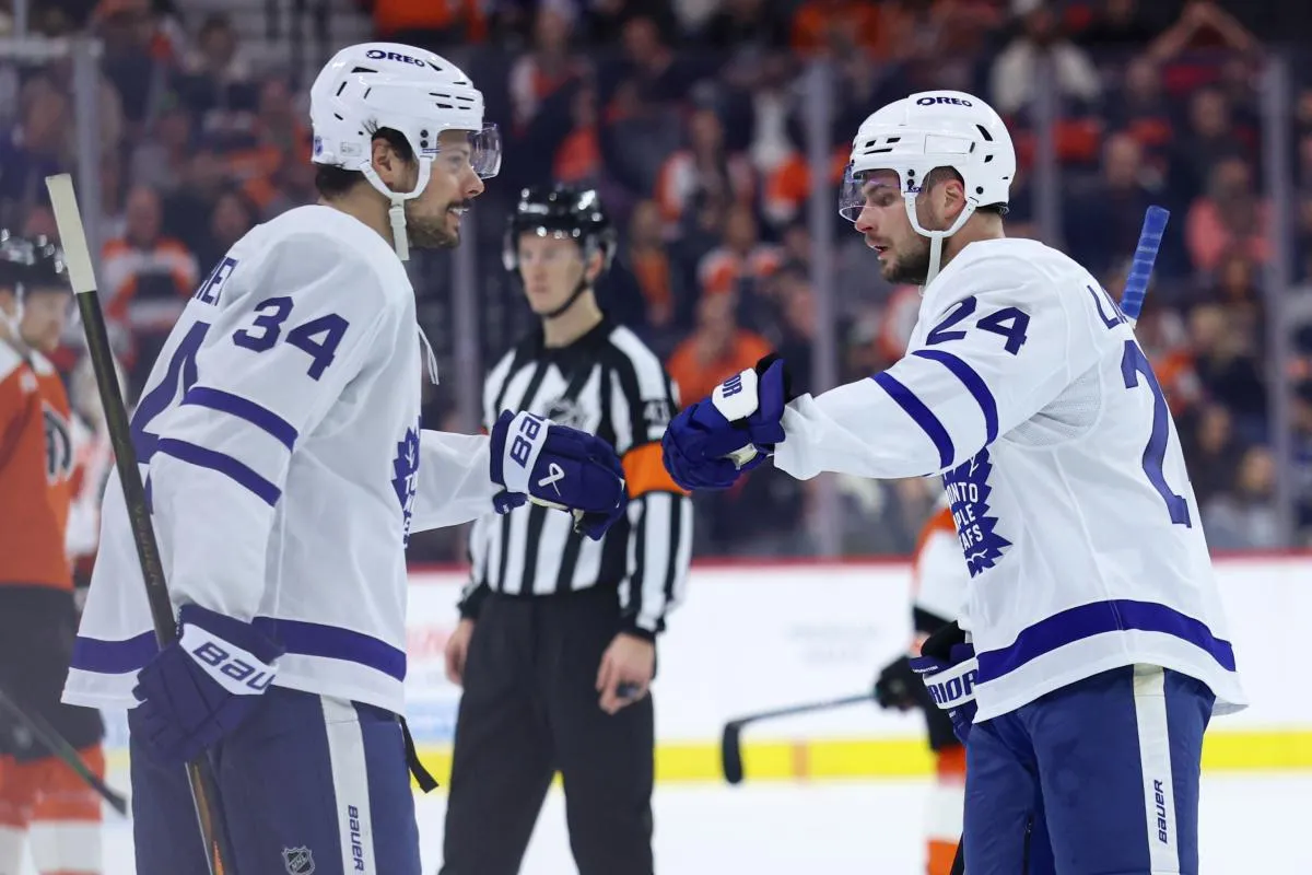 Toronto Maple Leafs center Scott Laughton (24) celebrates with center Auston Matthews (34) after scoring against the Philadelphia Flyers during the third period at Xfinity Mobile Arena.