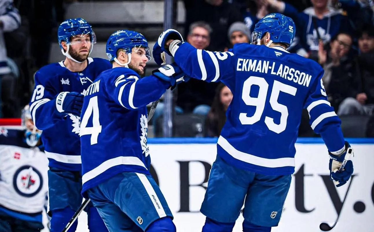Toronto Maple Leafs defenseman Oliver Ekman-Larsson (95) is congratulated by forward Scott Laughton (24) after scoring a goal against the Winnipeg Jets in the first period at Scotiabank Arena.