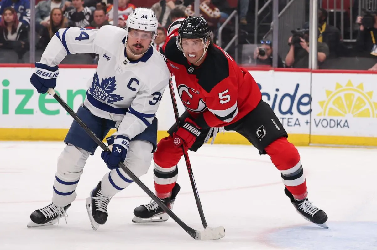 Toronto Maple Leafs center Auston Matthews (34) and New Jersey Devils defenseman Brenden Dillon (5) battle for position during the first period at Prudential Center.