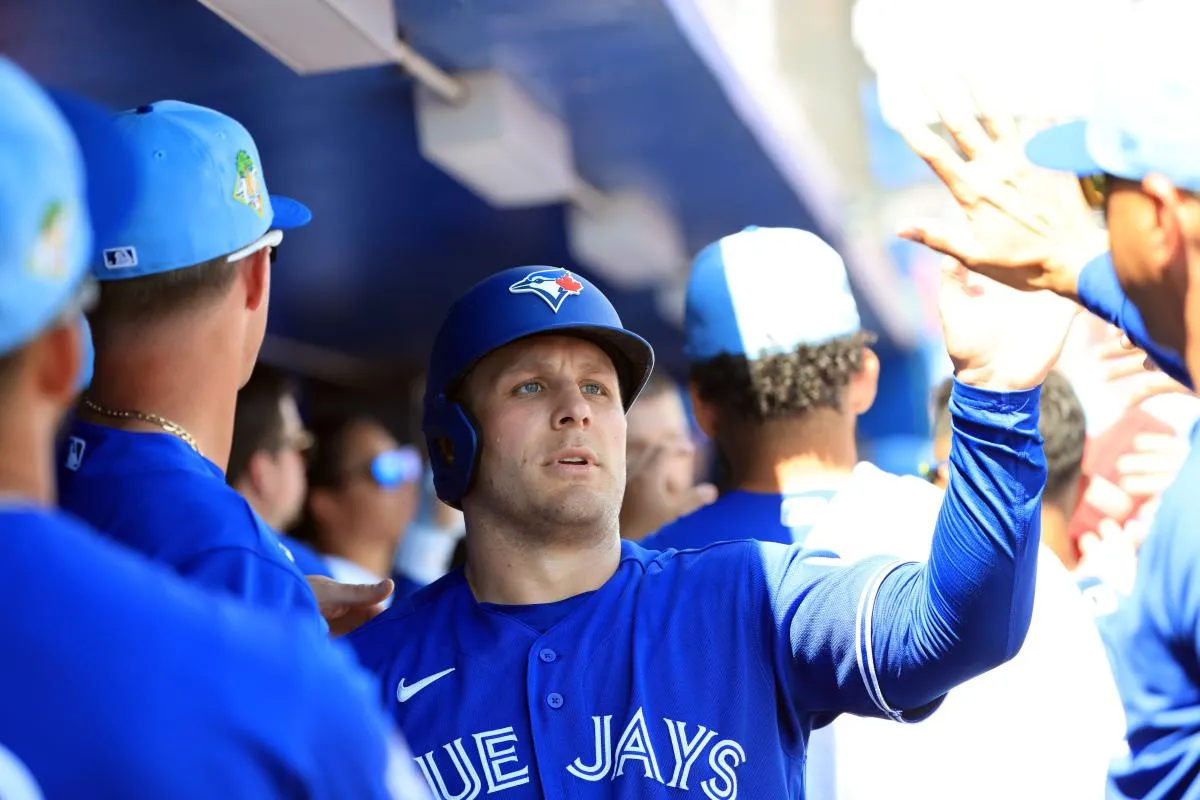 Toronto Blue Jays center fielder Daulton Varsho (5) is congratulated in the dugout after he scored during the first inning against Team Canada at TD Ballpark.