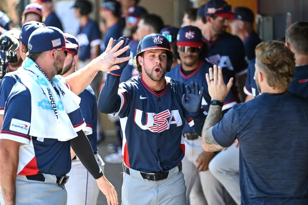 March 3, 2026: Ernie Clement high-fives his Team USA teammates in the dugout against the Colorado Rockies.
