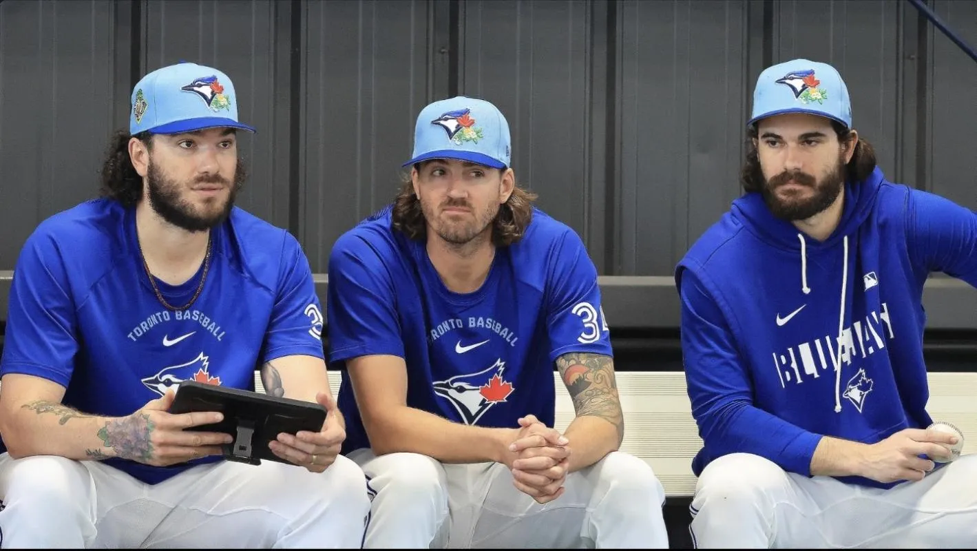 Toronto Blue Jays pitcher Kevin Gausman (34), pitcher Dylan Cease (84), pitcher Cody Ponce (37) watch the bullpen pitchers for spring training practice at Blue Jays Player Development Complex.