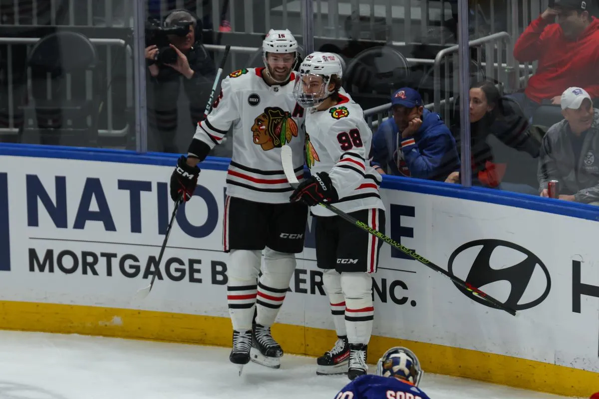 Chicago Blackhawks center Jason Dickinson (16) celebrates his goal with Chicago Blackhawks center Connor Bedard (98) against the New York Islanders during the first period at UBS Arena.