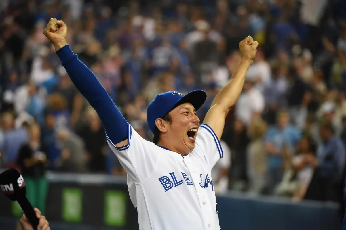 Toronto Blue Jays infielder Munenori Kawasaki (66) reacts to fans cheers during post-game celebrations afterthe Jays defeated Cleveland Indians 5-1 at Rogers Centre.