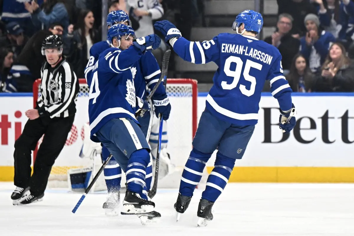 Toronto Maple Leafs defenseman Oliver Ekman-Larsson (95) is congratulated by forward Scott Laughton (24) after scoring a goal against the Winnipeg Jets in the first period at Scotiabank Arena