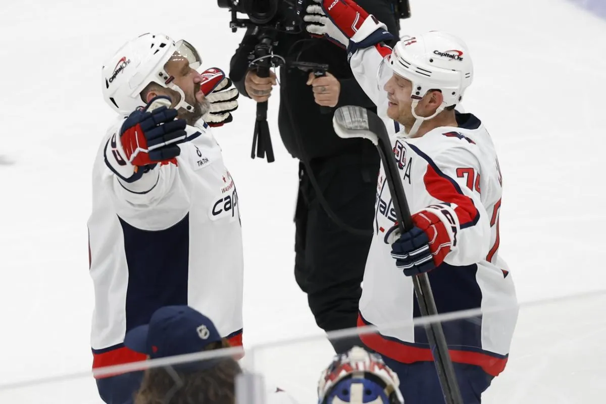 Washington Capitals left wing Alex Ovechkin (8) celebrates with defenseman John Carlson (74) after scoring a goal in the 2nd period against the New York Islanders at UBS Arena. The goal is the 895th of Ovechkin's career, breaking the NHL all-time career goals record previously held by Wayne Gretzky.at UBS Arena.