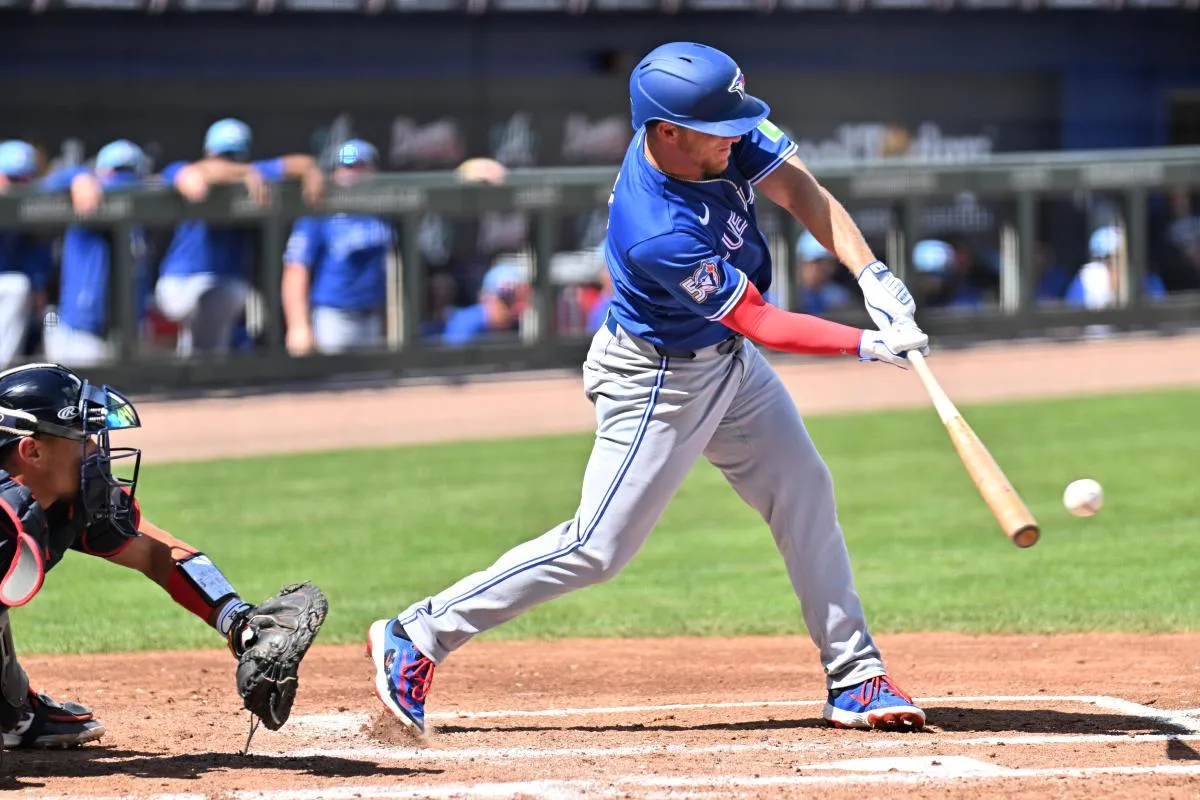 Toronto Blue Jays center fielder Myles Straw (3) hits a single in the third inning against the Atlanta Braves during spring training at CoolToday Park.