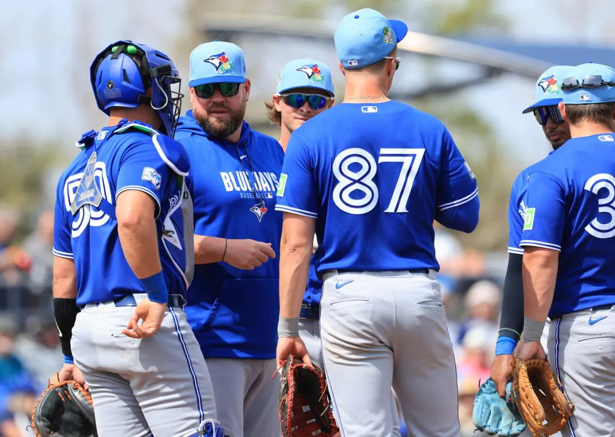 Toronto Blue Jays manager John Schneider (14) talks with catcher C.J. Stubbs (50) and first baseman Riley Triotta (87) on the mound during the second inning against the Toronto Blue Jays at Charlotte Sports Park.