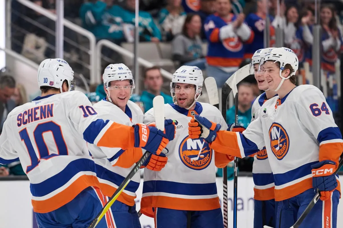 New York Islanders defenseman Tony DeAngelo (77) celebrates with center Brayden Schenn (10), left wing Ondrej Palat (81), defenseman Matthew Schaefer (48) and center Calum Ritchie (64) after scoring a goal against the San Jose Sharks during the first period at SAP Center at San Jose.