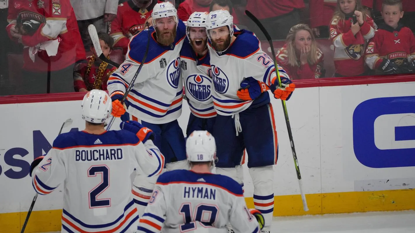 Edmonton Oilers forward Connor McDavid (97) celebrates scoring an empty net goal with defenseman Mattias Ekholm (14) and forward Adam Henrique (19) and defenseman Evan Bouchard (2) and forward Zach Hyman (18) during the third period against the Florida Panthers in game five of the 2024 Stanley Cup Final at Amerant Bank Arena.