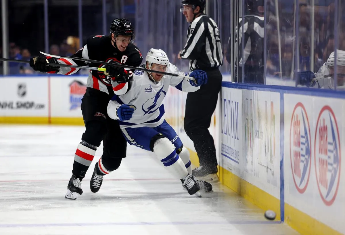 Buffalo Sabres center Tage Thompson (72) checks Tampa Bay Lightning defenseman Darren Raddysh (43) after he clears the puck during the first period at KeyBank Center.