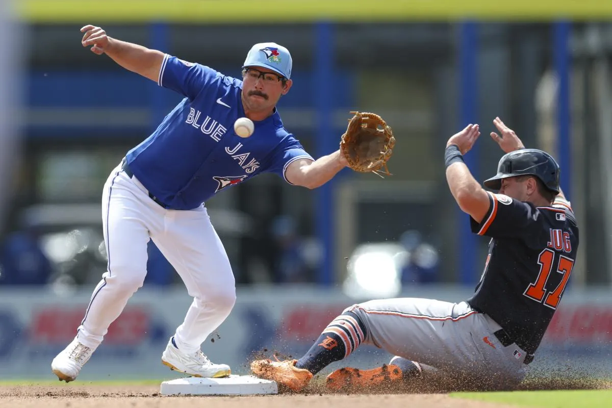 Detroit Tigers first baseman Jace Jung (17) slips safely into second base in front of Toronto Blue Jays second baseman Davis Schneider (36) in the second inning during spring training at TD Ballpark.