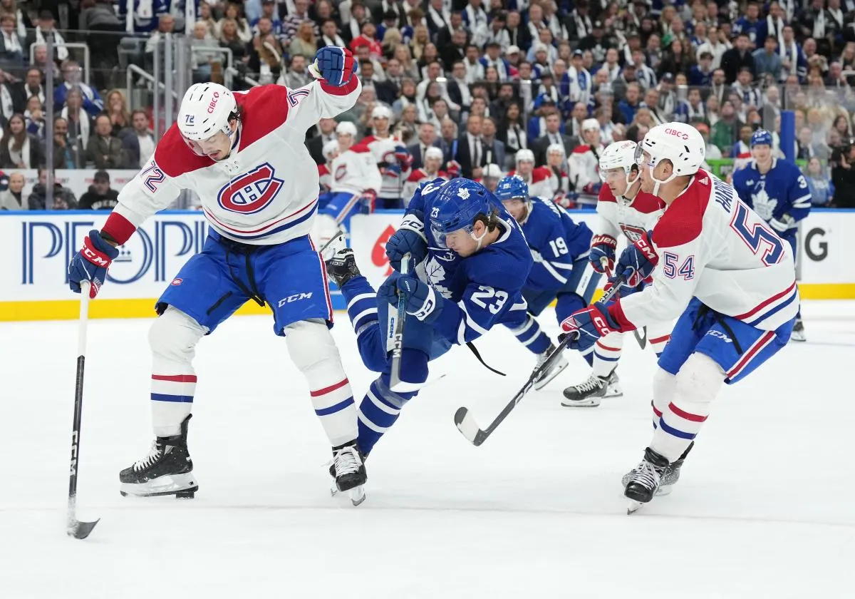 Toronto Maple Leafs left wing Matthew Knies (23) battles for the puck between Montreal Canadiens defenseman Arber Xhekaj (72) and defenseman Jordan Harris (54) during the third period at Scotiabank Arena.