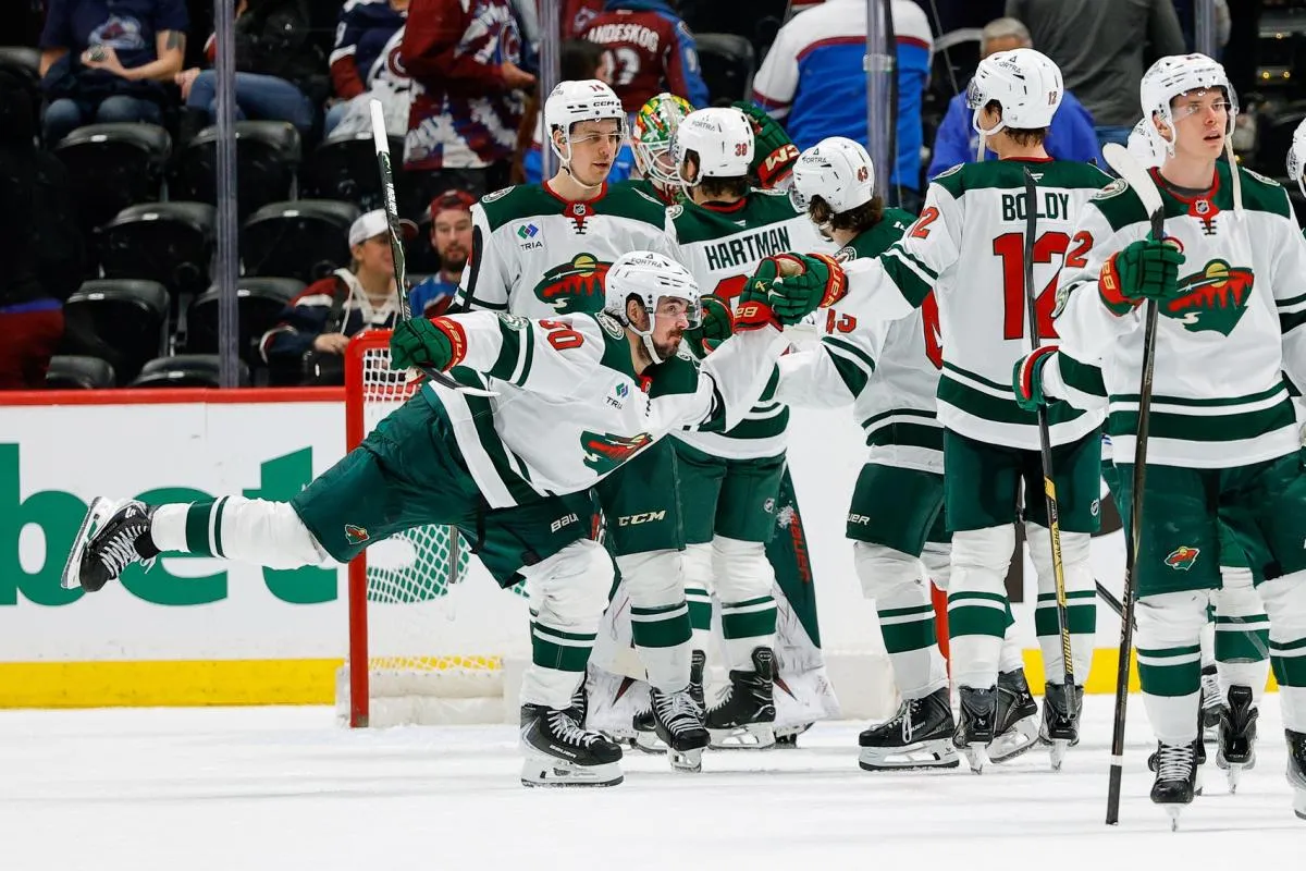 Minnesota Wild left wing Marcus Johansson (90) celebrates with left wing Matt Boldy (12) and teammates after the game against the Colorado Avalanche at Ball Arena.