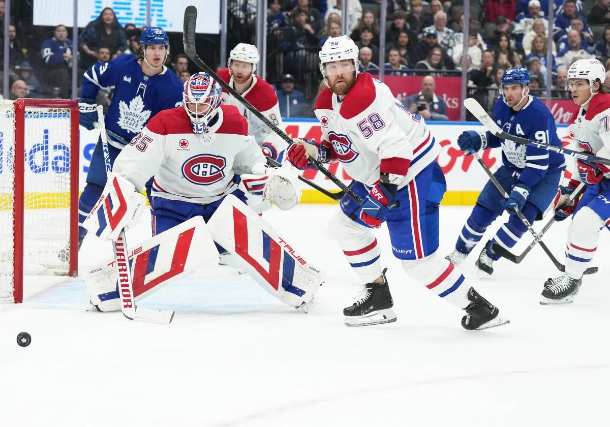 Montreal Canadiens defenseman David Savard (58) chases down a loose puck in front of the net as Toronto Maple Leafs left wing Matthew Knies (23) looks for the rebound during the third period at Scotiabank Arena.
