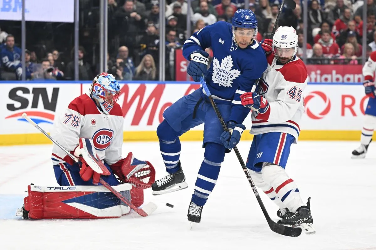 Montreal Canadiens goalie Jakub Dobes (75) makes a save as defenseman Alexandre Carrier (45) covers Toronto Maple Leafs forward Dakota Joshua (81) in the third period at Scotiabank Arena.