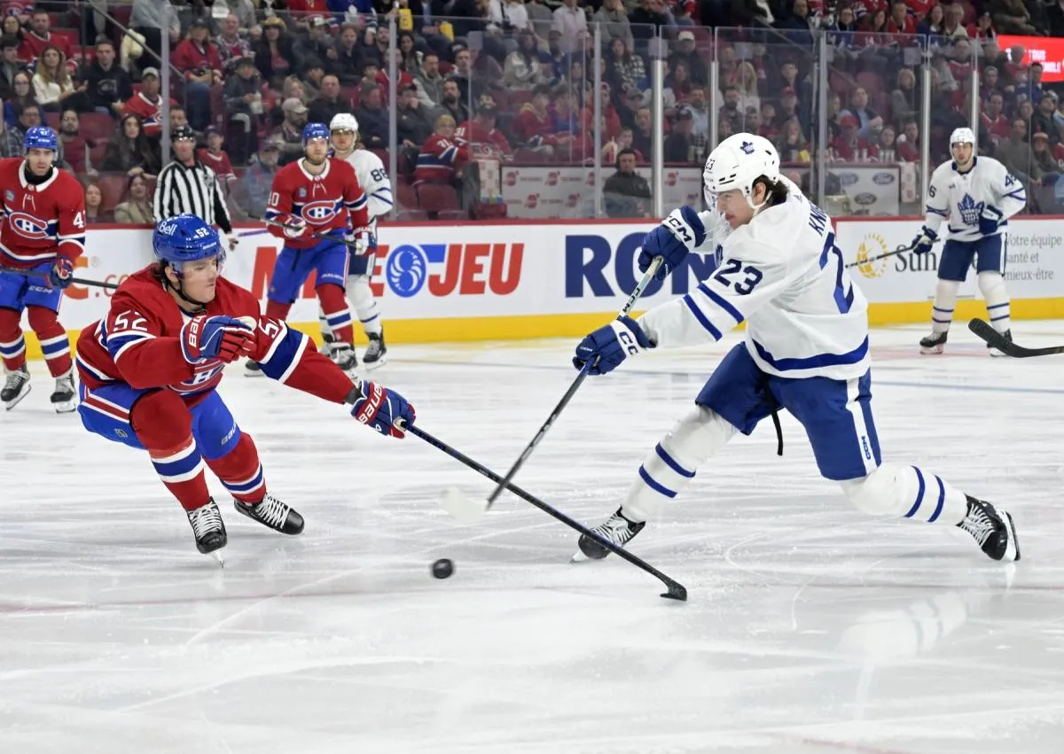 Toronto Maple Leafs forward Matthew Knies (23) takes as hot on net and Montreal Canadiens defenseman Justin Barron (52) defends during the first period at the Bell Centre.