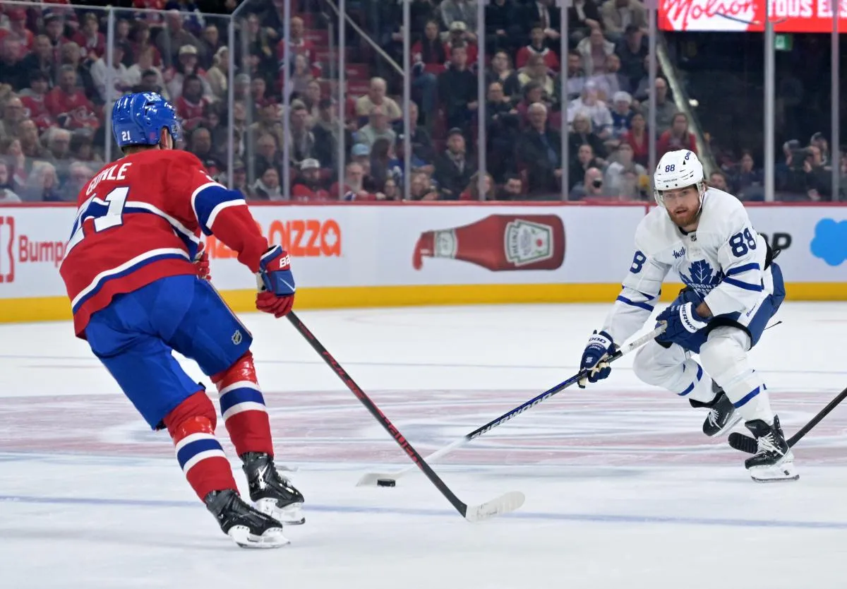 Toronto Maple Leafs forward William Nylander (88) plays the puck against Montreal Canadiens defenseman Kaiden Guhle (21) during the first period at the Bell Centre.