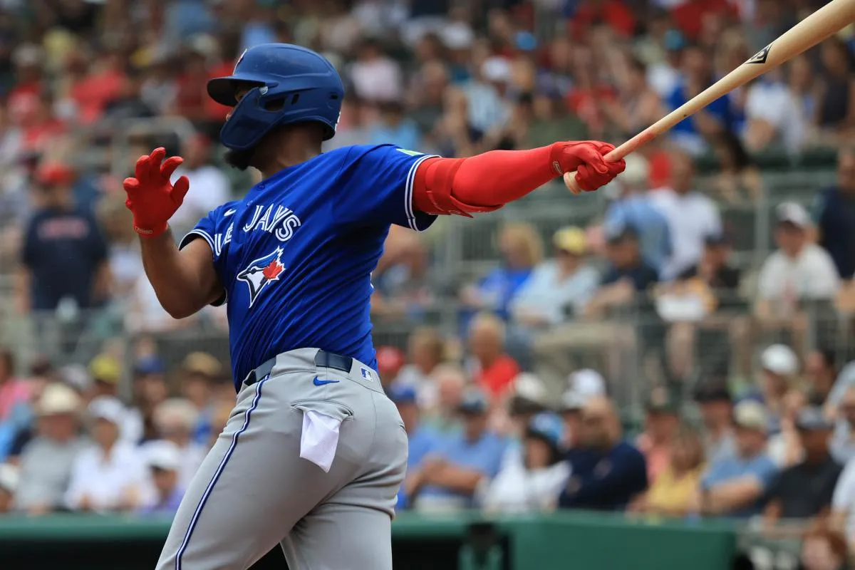 Toronto Blue Jays designated hitter Eloy Jimenez (74) hits an RBI double during the first inning against the Boston Red Sox at JetBlue Park at Fenway South.