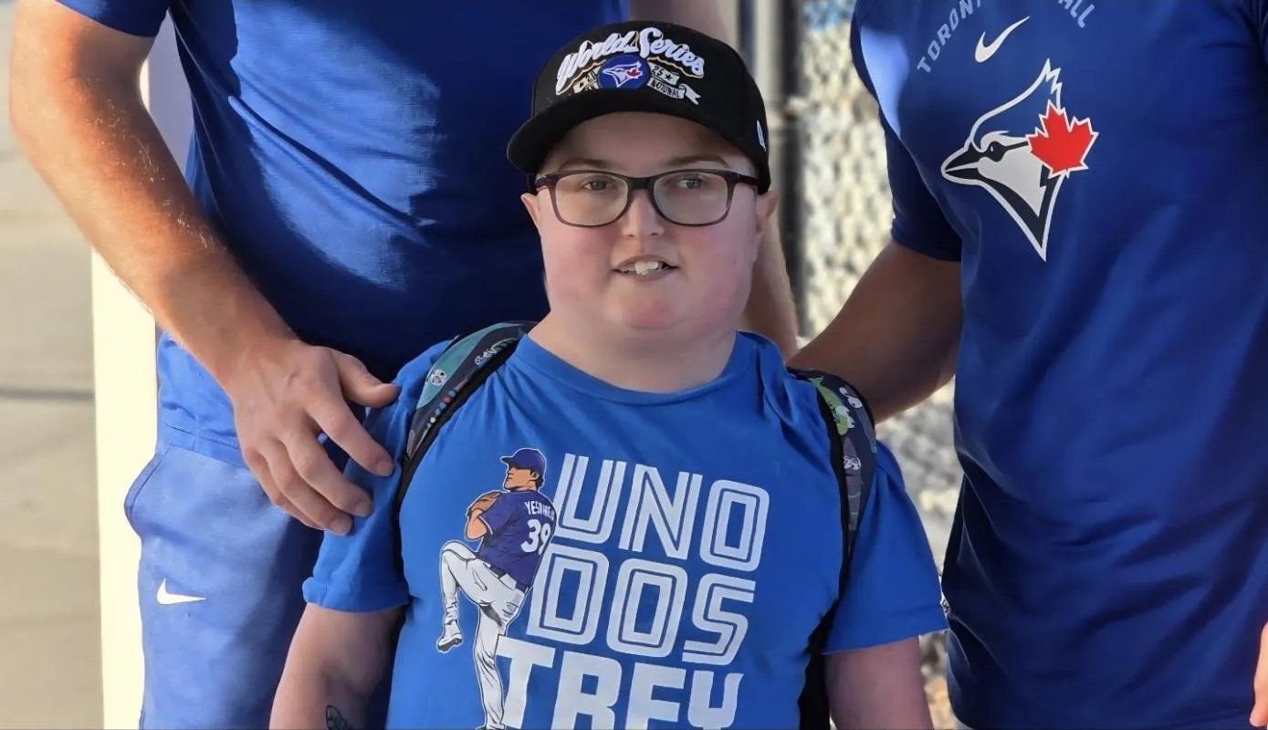 Toronto Blue Jays pitcher Trey Yesavage, young Blue Jays fan Wes Johnson, and Davis Schneider.