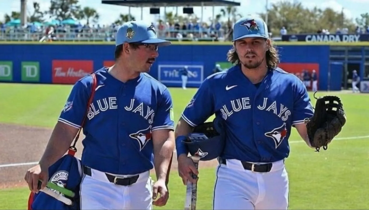 Toronto Blue Jays infielders/outfielders Davis Schneider and Addison Barger walk to the dugout at TD Ballpark in Dunedin Florida USA.