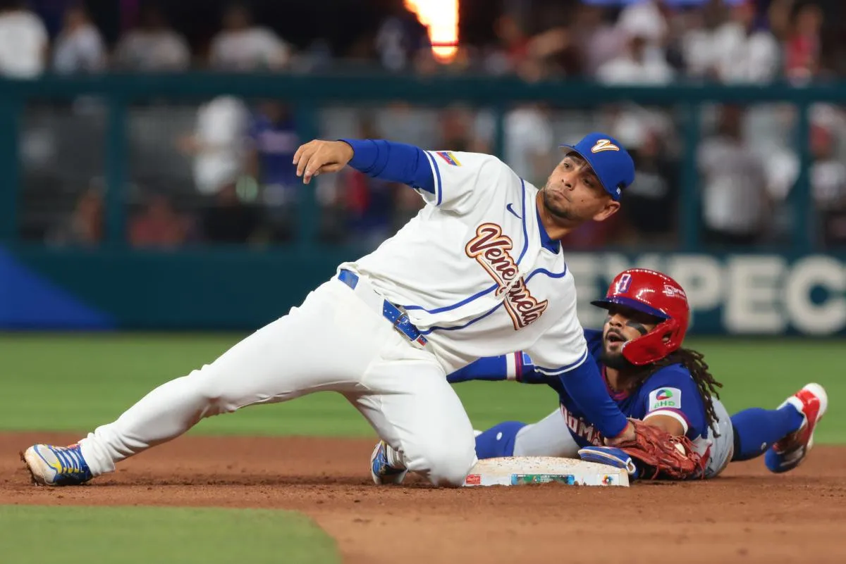 Venezuela shortstop Andres Gimenez (0) tags out Dominican Republic right fielder Fernando Tatis Jr. (23) during the ninth inning at loanDepot Park.