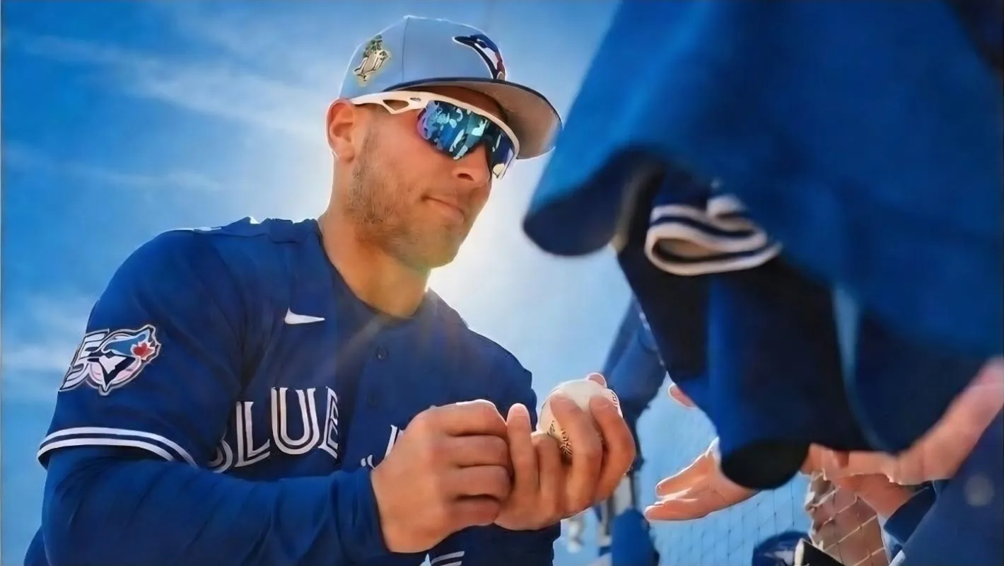 Toronto Blue Jays designated hitter Daulton Varsho (5) signs autographs before a spring training game against the New York Mets at TD Ballpark.