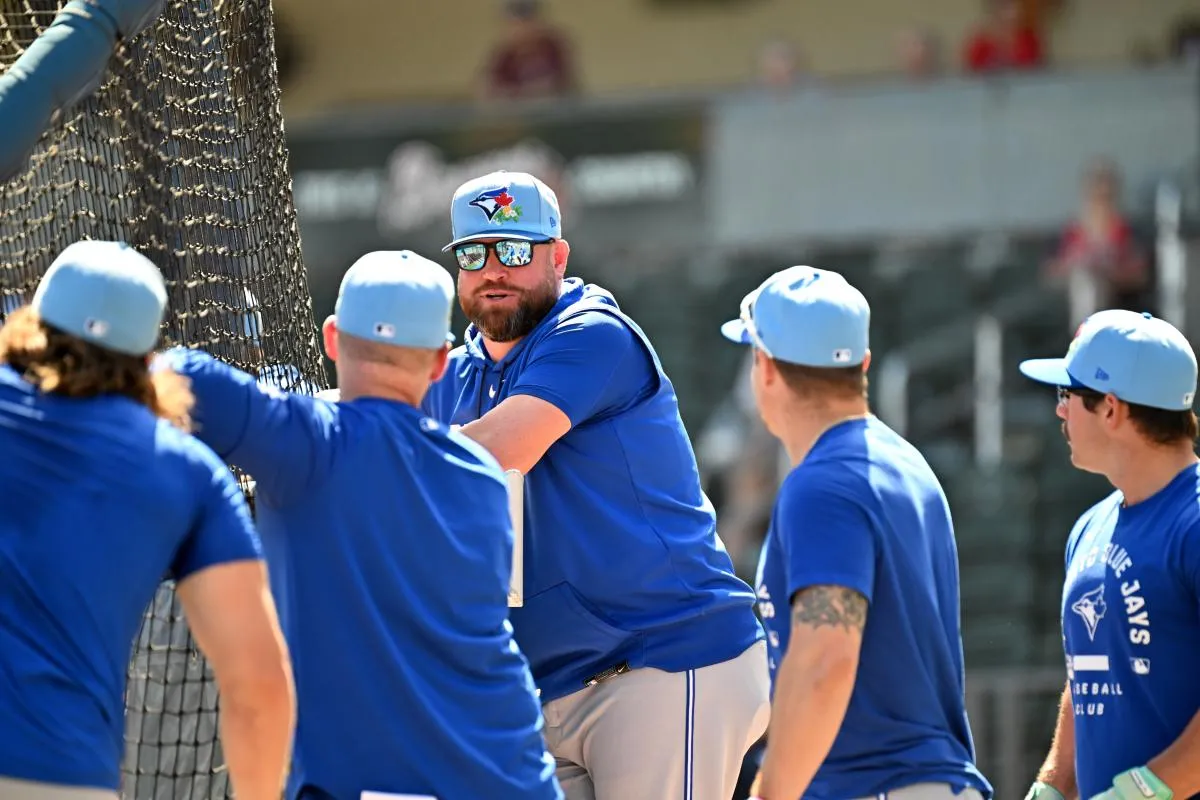 Toronto Blue Jays manager John Schneider (14) talks with a group of players before the start of the game against the Atlanta Braves during spring training at CoolToday Park.