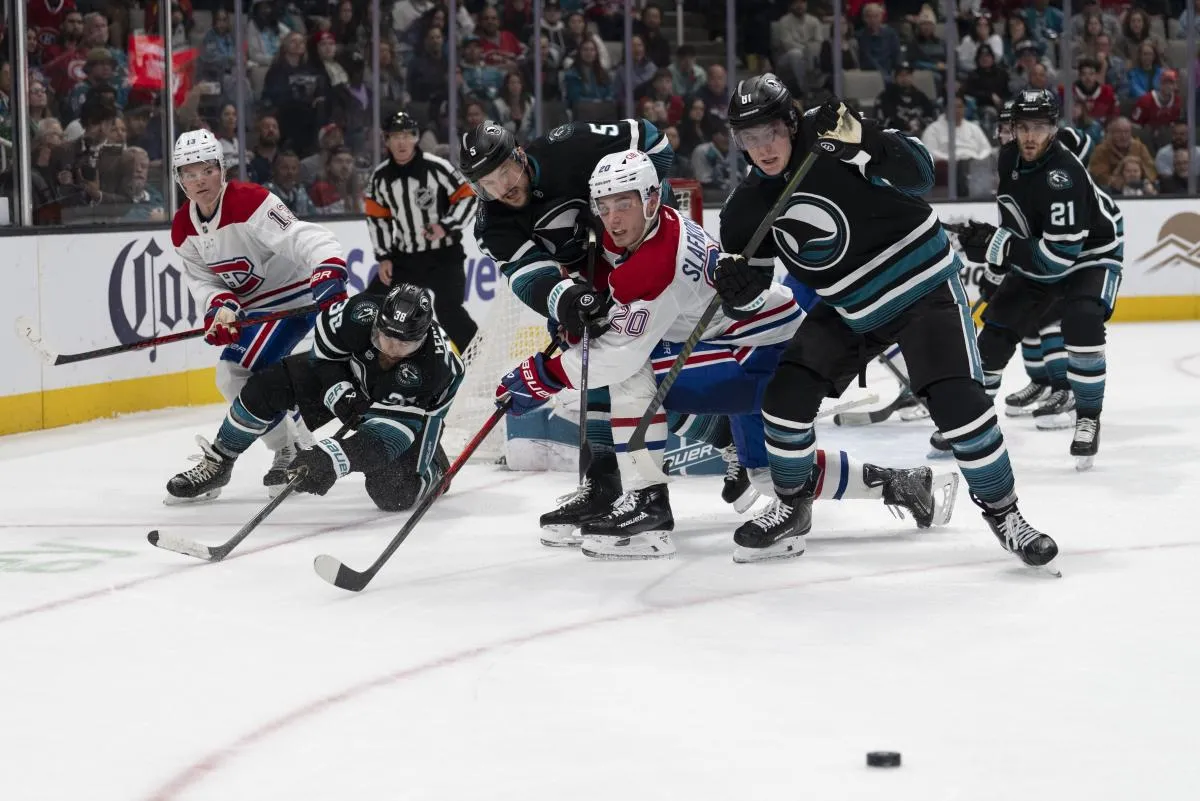 San Jose Sharks defenseman Vincent Desharnais (5) , right wing Adam Gaudette (81) defenseman Mario Ferraro (38) , Montreal Canadiens left wing Juraj Slafkovsk&yacute; (20) and right wing Cole Caufield (13) watches the puck go past them during the third period at SAP Center at San Jose.
