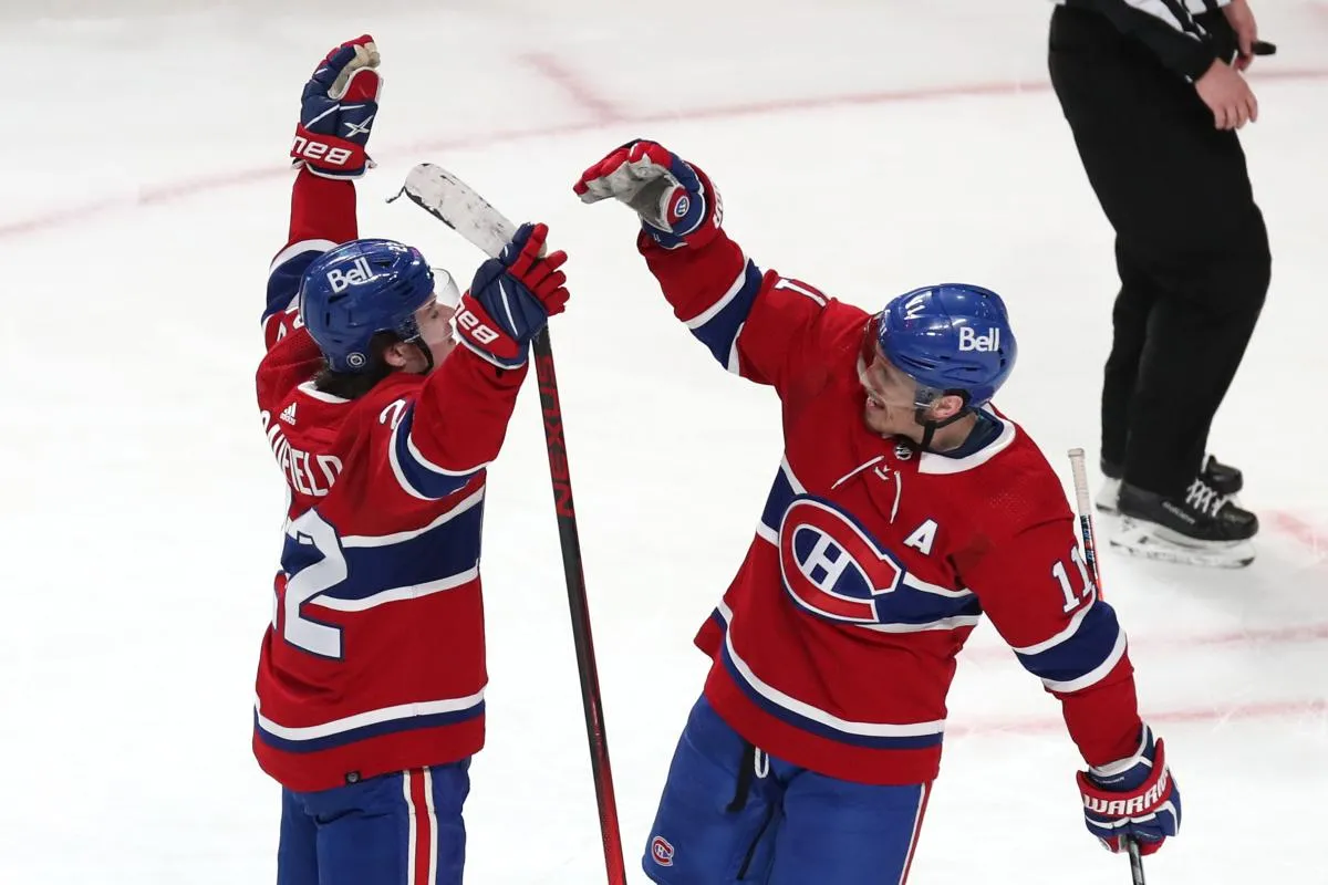 Montreal Canadiens right wing Cole Caufield (22) celebrates his goal against Ottawa Senators with teammate right wing Brendan Gallagher (11) during the second period at Bell Centre.