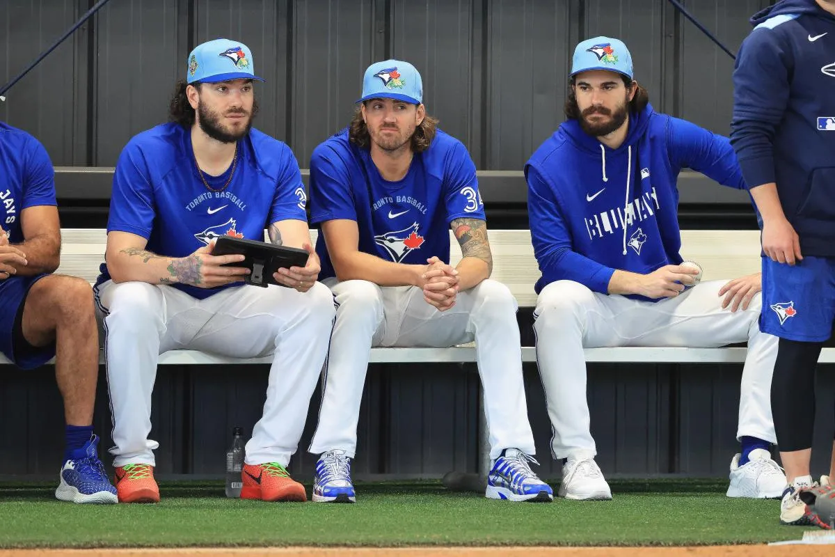 Toronto Blue Jays pitcher Kevin Gausman (34), pitcher Dylan Cease (84), pitcher Cody Ponce (37) watch the bullpen pitchers for spring training practice at Blue Jays Player Development Complex.