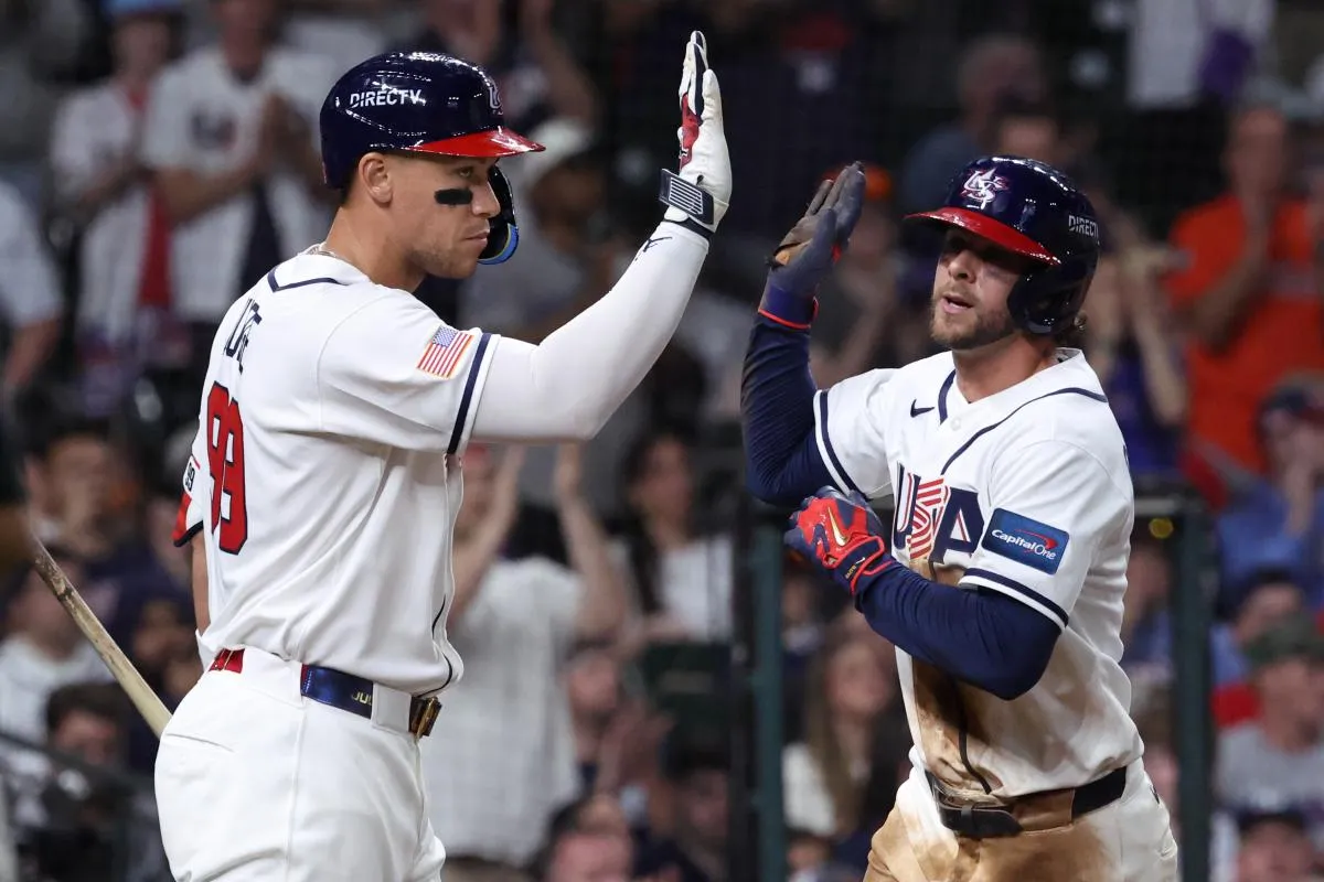 United States right fielder Aaron Judge (99) congratulates third baseman Ernie Clement (5) after scoring a run against Great Britain during the sixth inning at Daikin Park.