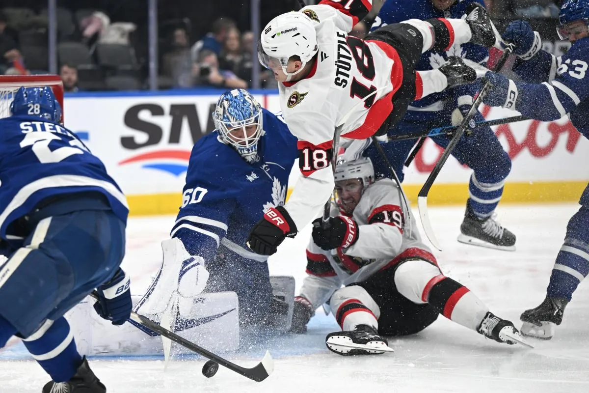 Ottawa Senators forward Tim Stutzle (18) flies over forward Drake Batherson (19) pursing a rebound after a save by Toronto Maple Leafs goalie Joseph Woll (60) in the second period at Scotiabank Arena.