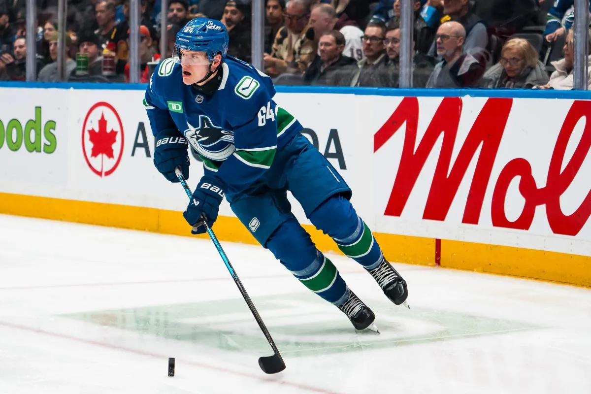 Vancouver Canucks forward David Kampf (64) handles the puck against the Carolina Hurricanes in the second period at Rogers Arena.