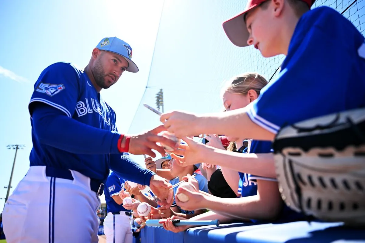 Toronto Blue Jays designated hitter George Springer (4) signs autographs before the start of the game against the Philadelphia Phillies during spring training at TD Ballpark.