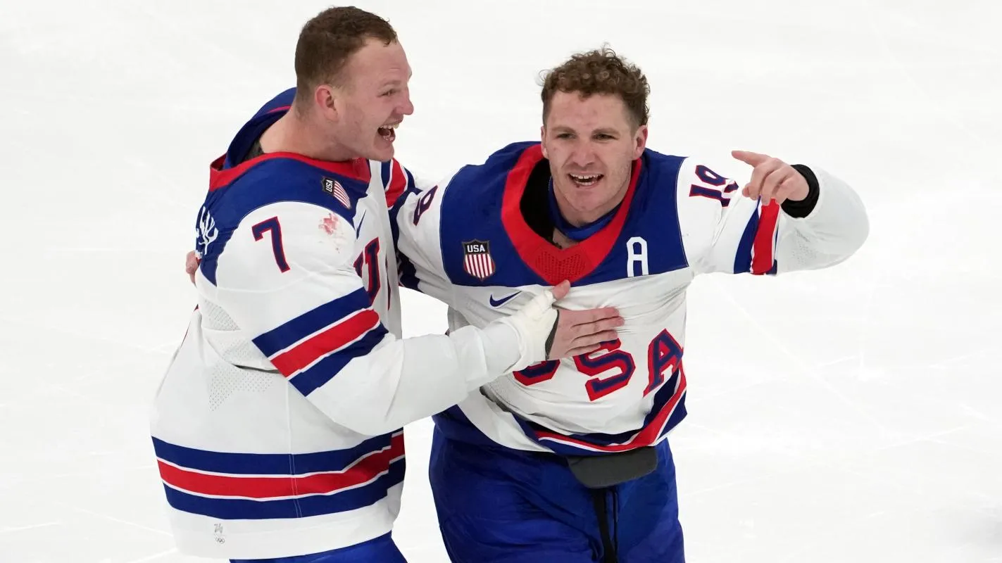 Matthew Tkachuk and Brady Tkachuk celebrate after winning the men's ice hockey gold medal game during the Milano Cortina 2026 Olympic Winter Games at Milano Santagiulia Ice Hockey Arena.