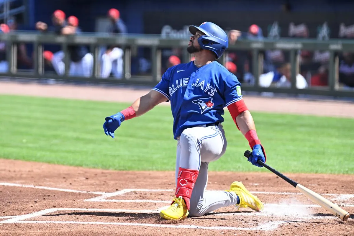 Toronto Blue Jays left fielder Jonatan Clase (8) hits a sacrifice fly ball in the second inning against the Atlanta Braves during spring training at CoolToday Park.