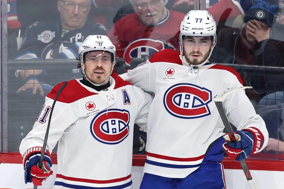 Montreal Canadiens right wing Brendan Gallagher (11) celebrates a goal against the Winnipeg Jets with center Kirby Dach (77) in the third period at Canada Life Centre.