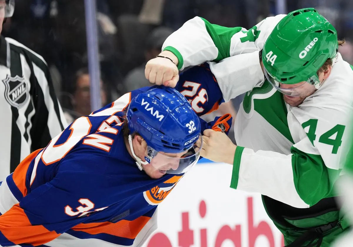 Toronto Maple Leafs defenseman Morgan Rielly (44) fights with New York Islanders center Kyle MacLean (32) during the second period at Scotiabank Arena.