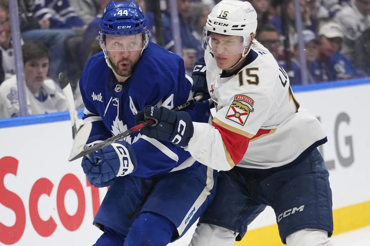 Florida Panthers forward Anton Lundell (15) checks Toronto Maple Leafs defenceman Morgan Rielly (44) during the second period of game seven of the second round of the 2025 Stanley Cup Playoffs at Scotiabank Arena.