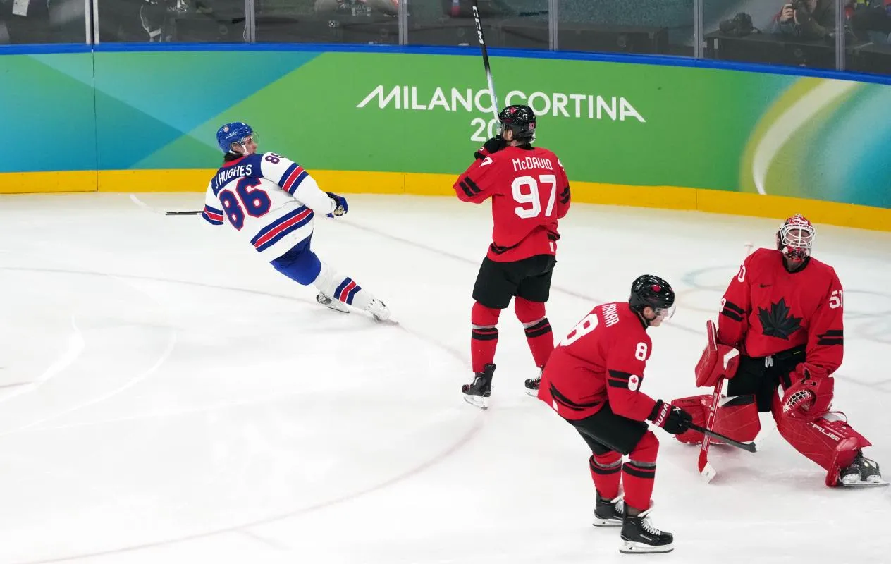 Jack Hughes (86) of the United States celebrates after winning the men's ice hockey gold medal game as Canada defenseman Cale Makar (8) and center Connor Mcdavid (97) and goalie Jordan Binnington (50) look on during the Milano Cortina 2026 Olympic Winter Games at Milano Santagiulia Ice Hockey Arena.