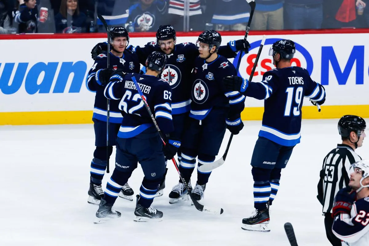 Winnipeg Jets defenseman Neal Pionk (4) is congratulated by his team mates on his goal against the Columbus Blue Jackets during the second period at Canada Life Centre.