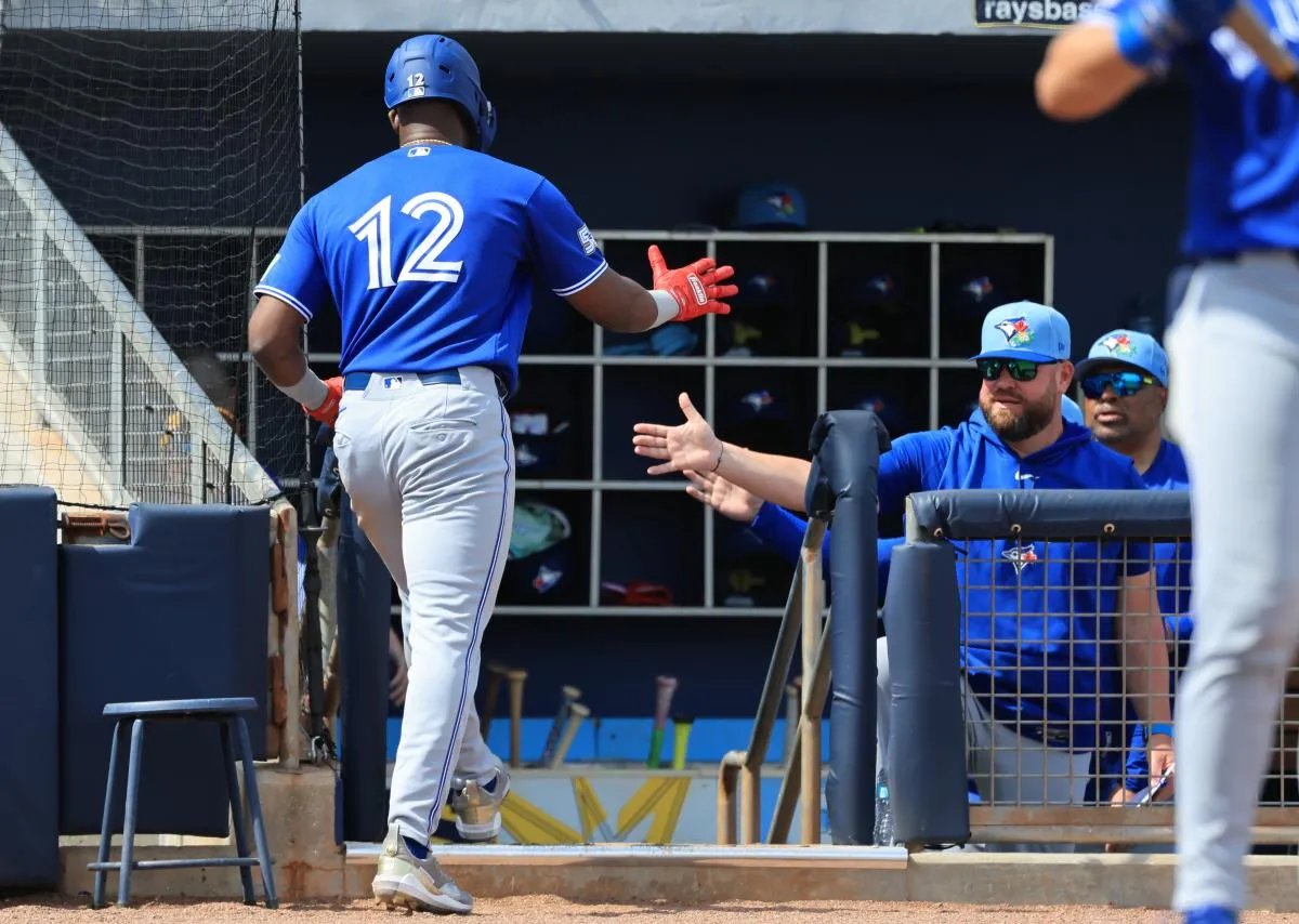 Toronto Blue Jays right fielder Jesus Sanchez (12) is congratulated by manager John Schneider (14) after he scored during the second inning against the Tampa Bay Rays at Charlotte Sports Park.