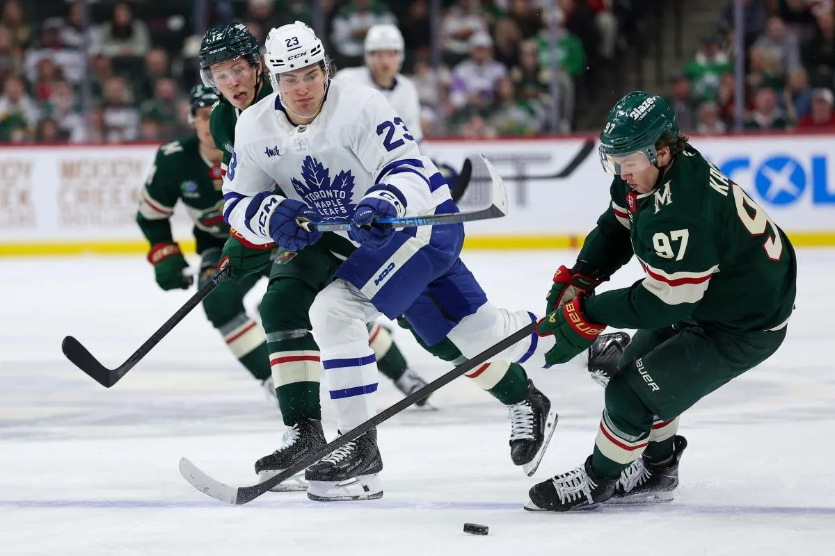 Toronto Maple Leafs left wing Matthew Knies (23) and Minnesota Wild left wing Kirill Kaprizov (97) compete for the puck during the third period at Grand Casino Arena.