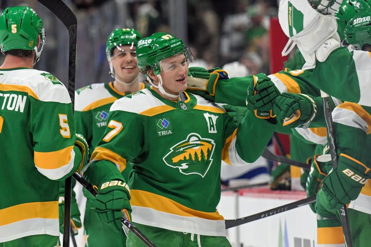 Minnesota Wild forward Kirill Kaprizov (97) is congratulated by teammates after taking sole possession as the franchise leader in goals on an empty netter against the Tampa Bay Lightning during the third period at Grand Casino Arena.